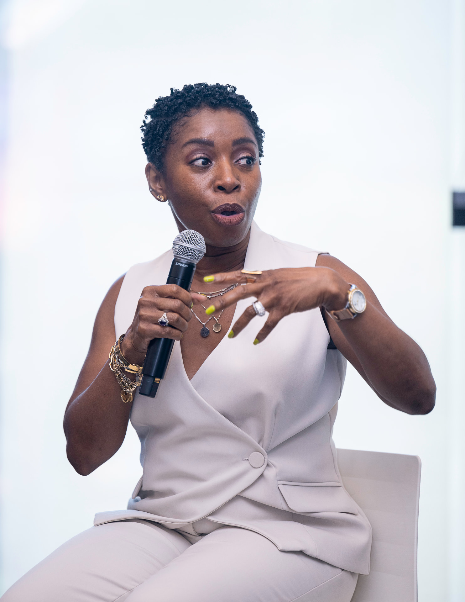 Moniek James speaking on a summit panel with a microphone